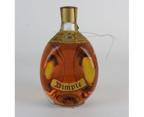 A bottle of Dimple Old Blended Scotch Whiskey, 70% old proof, 20 2/3floz, along with a bottle of Golden Bells Delux 12 year o
