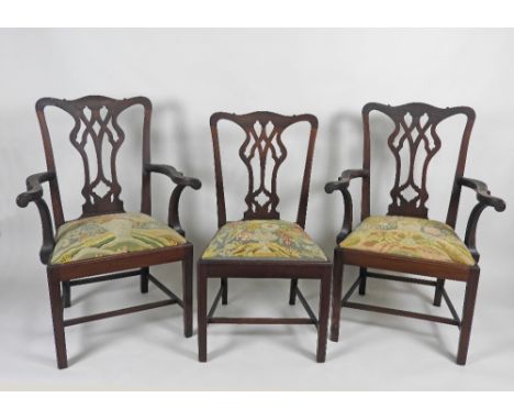 A set of twelve mahogany Chippendale style dining chairs including two carvers each with a pierced vase shape back splat, dro