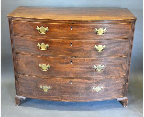 A 19th Century Mahogany Bow Fronted Chest of four graduated drawers with brass handles flanked by reeded columns and raised u