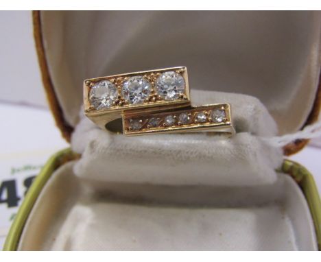 18ct YELLOW GOLD DIAMOND RING of geometric design, set with 3 brilliant cut diamonds in 1 row and 6 small accent brilliant cu