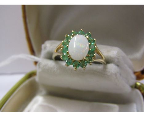 9ct YELLOW GOLD OPAL &amp; EMERALD CLUSTER RING, central oval cut opal surrounded by brillinat cut emeralds in 9ct gold setti