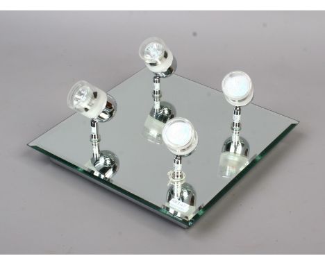 An unusual wall mounted low voltage chrome and mirrored light fitting with four adjustable spot lights.