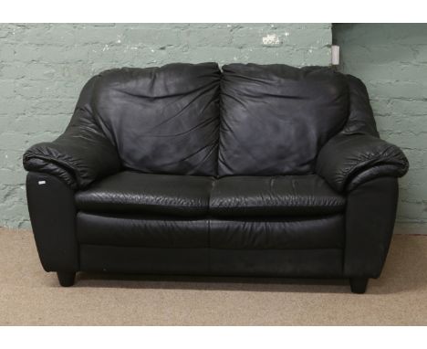 A black leather two seat sofa.