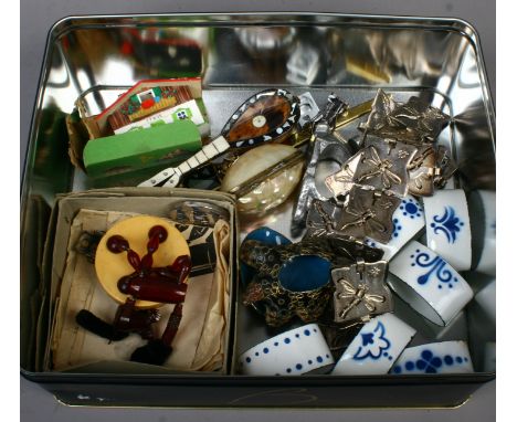 A tin of collectables including enamel napkin rings, cloisonne turtle and tortoise shell model of a lute etc.