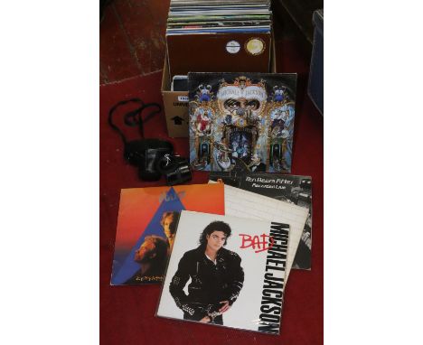A box of L.P and 45s to include Pink Floyd, Jimi Hendrix, Michael Jackson etc along with a Pentax 50 mm lenses camera and cas