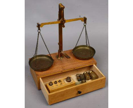 A set of vintage apothecary balance scales and weights.