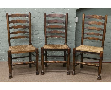 A set of six rush seat ladder back chairs.