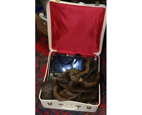 A vintage Garstin travel case and contents of fur stoles and handbags.