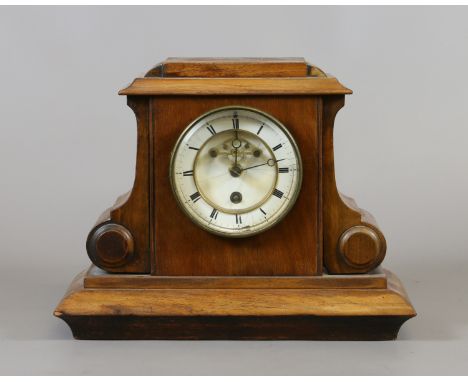 A William IV walnut eight day mantel clock with enamel dial and visible anchor escapement.