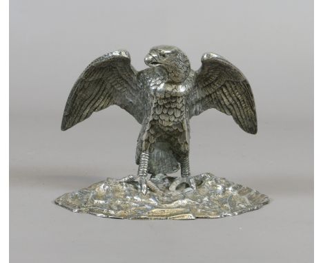 A George V silver plated inkwell formed as an eagle perched on a rockwork base.