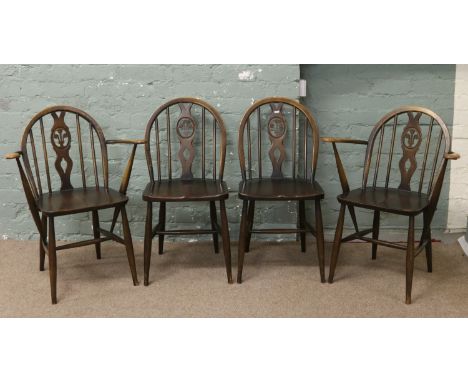 A set of four Ercol dining chairs with carved Prince of Wales feathers motif.