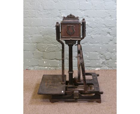 A set of antique W & T Avery cast iron shop scales with wrought iron detail.