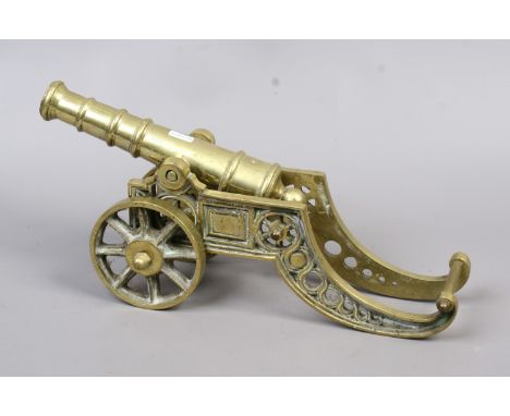 A cast brass model of cannon standing 21cm high and 45cm long.
