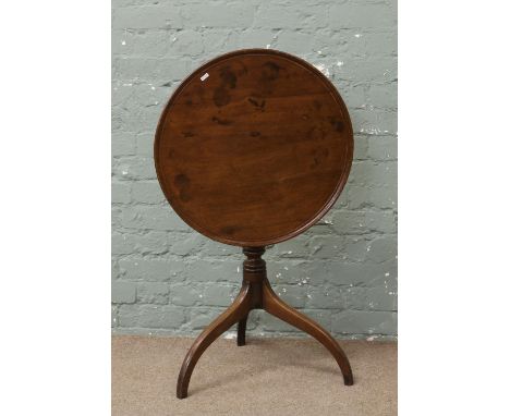 A Victorian mahogany fold over table raised on turned tripod base.