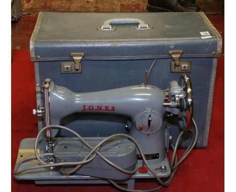 A cased vintage Jones model D-65 electric sewing machine.