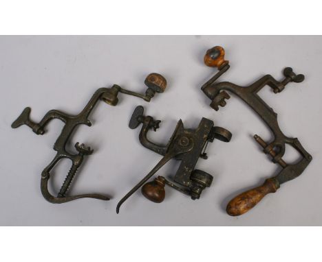 Three vintage shotgun cartridge case loaders.