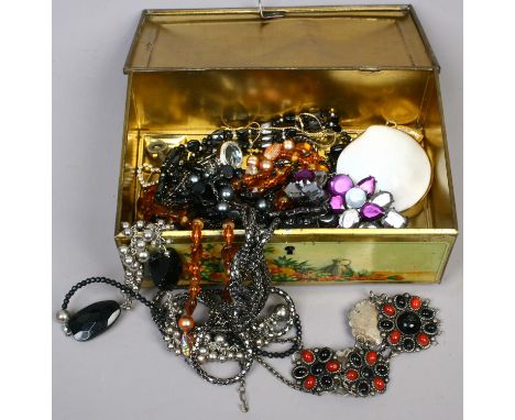 A tin of costume jewellery to include necklaces, shell effect trinket box etc.