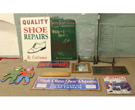 A collection of assorted cobblers and shoe shop signs including vintage examples. Includes VAT on hammer.
