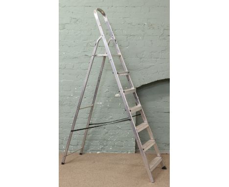 A pair of six tread alluminium step ladders. Includes VAT on hammer.