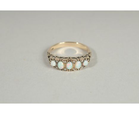 A 9CT GOLD FIVE STONE OPAL RING.