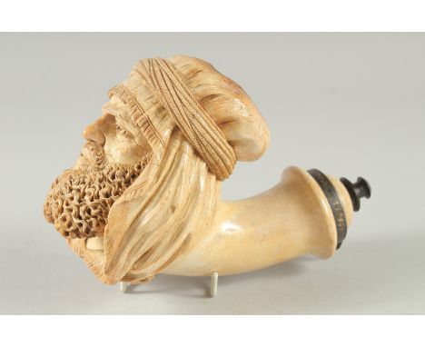 A SUPERB CARVED MEERSCHAUM PIPE CARVED AS AN ARAB MAN'S HEAD. with a long beard and head cover. 15cm long, 12 cm deep.