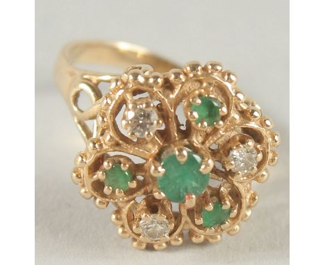 A 14CT GOLD DIAMOND AND EMERALD CLUSTER RING