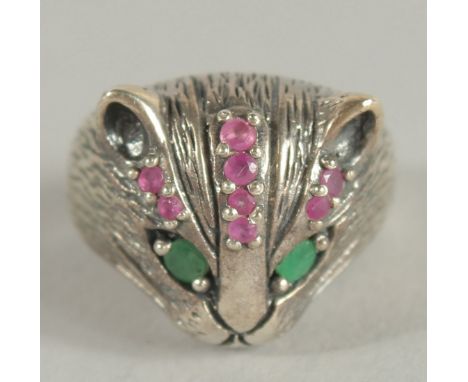 A SILVER CAT'S FACE RING with ruby eyes.