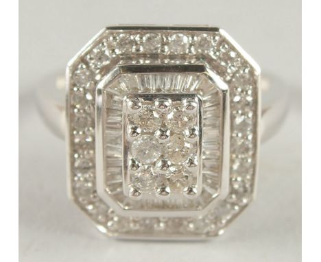 A 14CT WHITE GOLD SQUARE SHAPED DIAMOND RING.