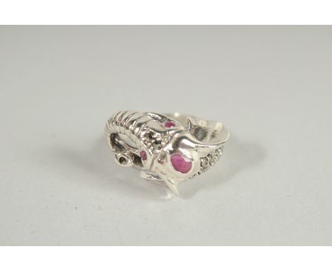 A SILVER RUBY SET ELEPHANT RING.