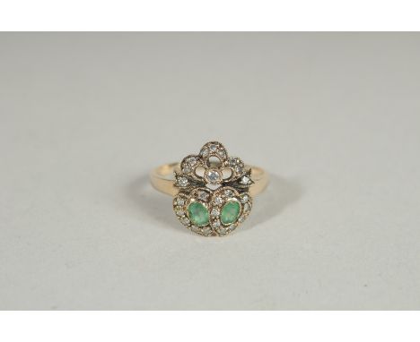 A 9CT GOLD EMERALD AND DIAMOND SWEETHEART RING.