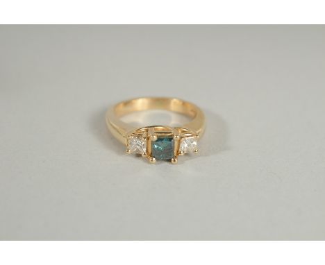 A 14K GOLD BLUE DIAMOND AND DIAMOND THREE STONE, PRINCESS CUT RING.