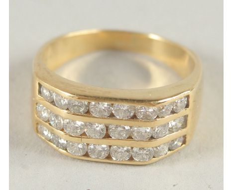 AN 18CT GOLD TRIPLE DIAMOND BAND RING.