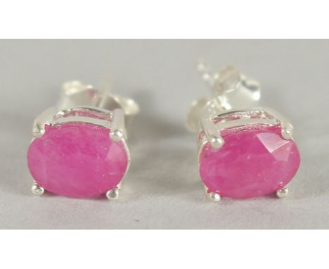 A PAIR OF SILVER AND REAL RUBY STUD EARRINGS.