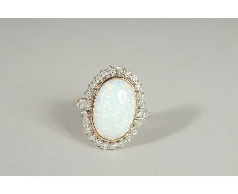 A 9CT GOLD OPAL AND DIAMOND OVAL RING.