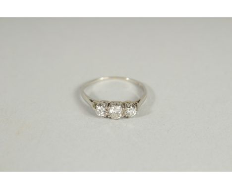 AN 18CT GOLD THREE STONE GRADUATED  DIAMOND RING.