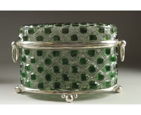 A GREEN GLASS AND SILVER PLATED OVAL CASKET with ring handles on ball feet. 14ins long.