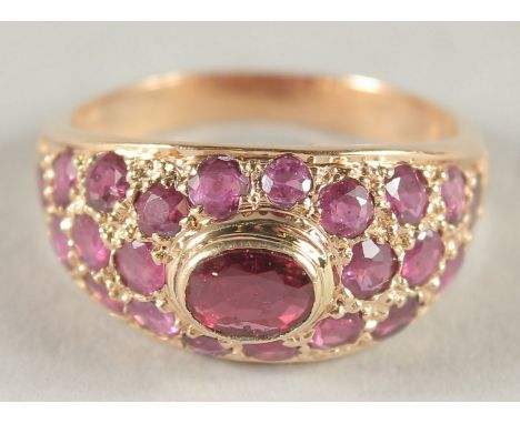 A 14CT GOLD RUBY GYPSY RING.