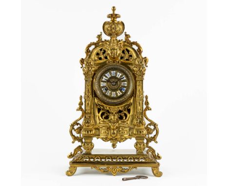 A mantle clock, gilt bronze. 20th century.&nbsp;Dimensions: (L:16 x W:25 x H:45 cm)