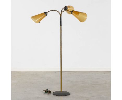 A mid-century floorlamp, cast-iron, brass and acrylic.The light-arms&nbsp;are adjustable and can be pointed in any direction.