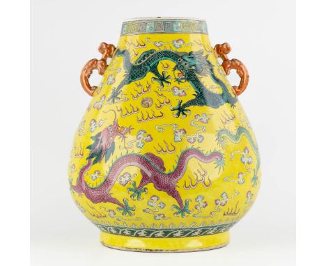 A large yellow Chinese vase with a dragon decor, Kangxi mark, 19th century.&nbsp;Dimensions: (H:47 x D:37 cm)