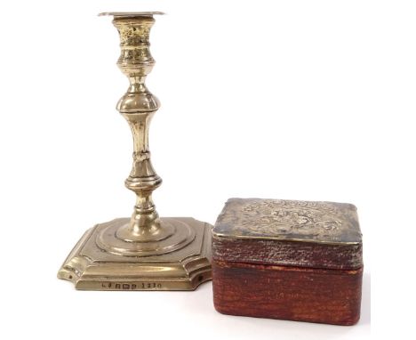 An Edwardian silver candlestick, the shaped stem on an inverted square and stepped base, Birmingham 1903, 10cm high and a cas