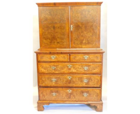 A mid 18thC and later walnut cabinet, the upper section with a crossbanded and veneered moulded top, above two doors enclosin