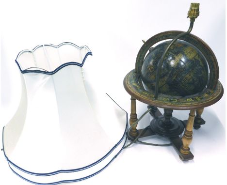 A 20thC table lamp, adapted from a globe, with fabric shade.