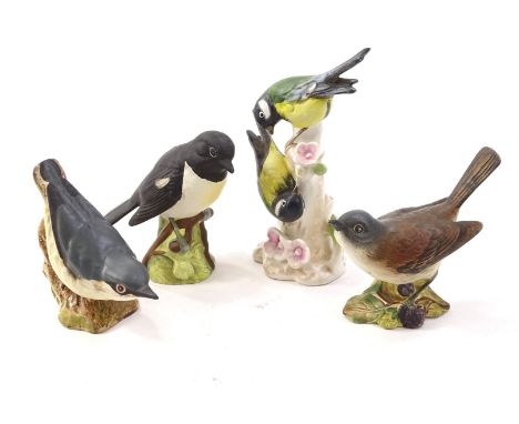 Four ceramic birds, to include a Beswick Stonechat, a White throat, a Nuthatch and a pair of Goebel blue tits. 