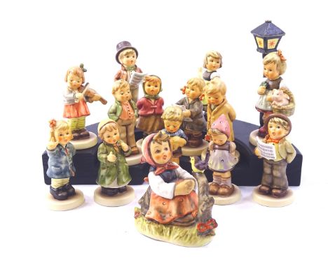 Various Hummel figures, to include violinist, singers etc., and a stand.