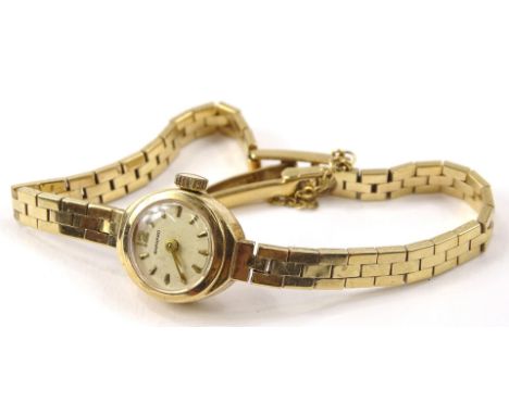 A 9ct gold Garrard ladies cocktail watch, with small circular watch head, on three row strap, inscribed to back Ruston Bucyru