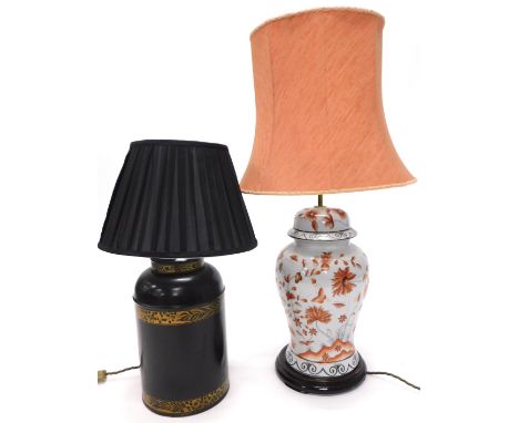 A table lamp, modelled in the form of a tea canister, with ebonised and gilt bands, pleated black fabric shade, 60cm high ove