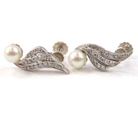 A pair of 18ct white gold screw on earrings, of a fan design, with single cultured pearl and three row round brilliant cut di