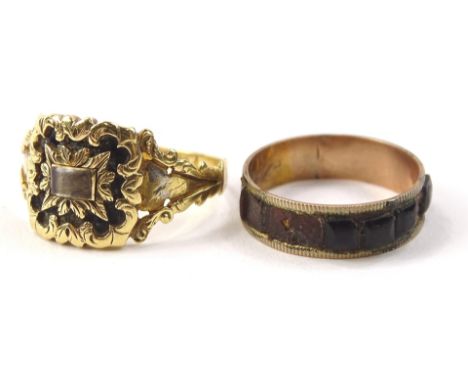 Two dress rings, to include an 18ct gold memorial ring, with black enamel decoration and memorial locket to centre, some enam