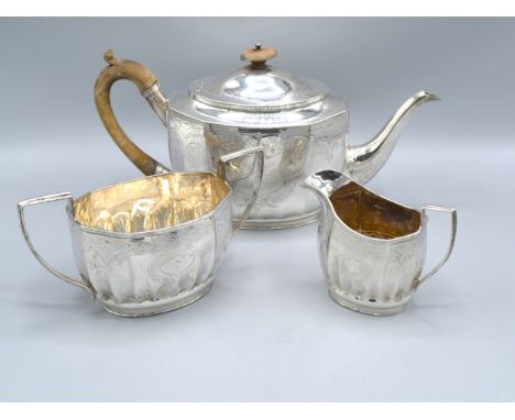 A Matched Three Piece Silver Tea Service comprising teapot, Sheffield 1897, and a matched two handled sucrier and cream jug, 